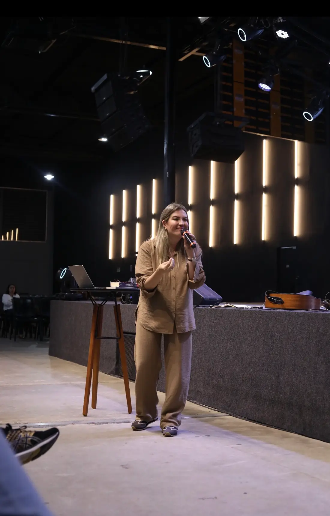 Pra. Gisele conduzindo um encontro em auditório